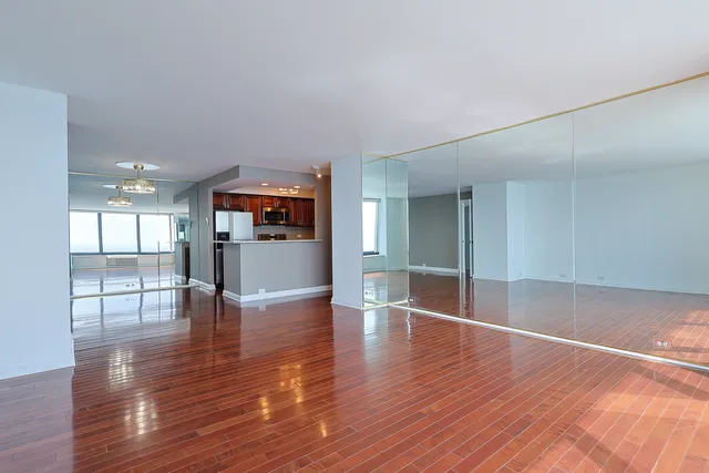 a view of a living room kitchen and a wooden floor