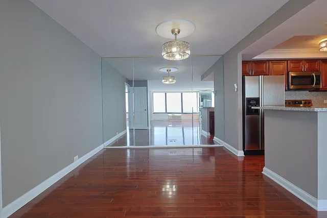 a view of a kitchen with a sink wooden floor and a large window