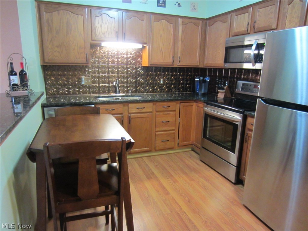 1202 Windmill Way South Avon, OH 44011 - Photo 3 of 23 Kitchen offers granite counters, newer stainless appliances and designer look.
