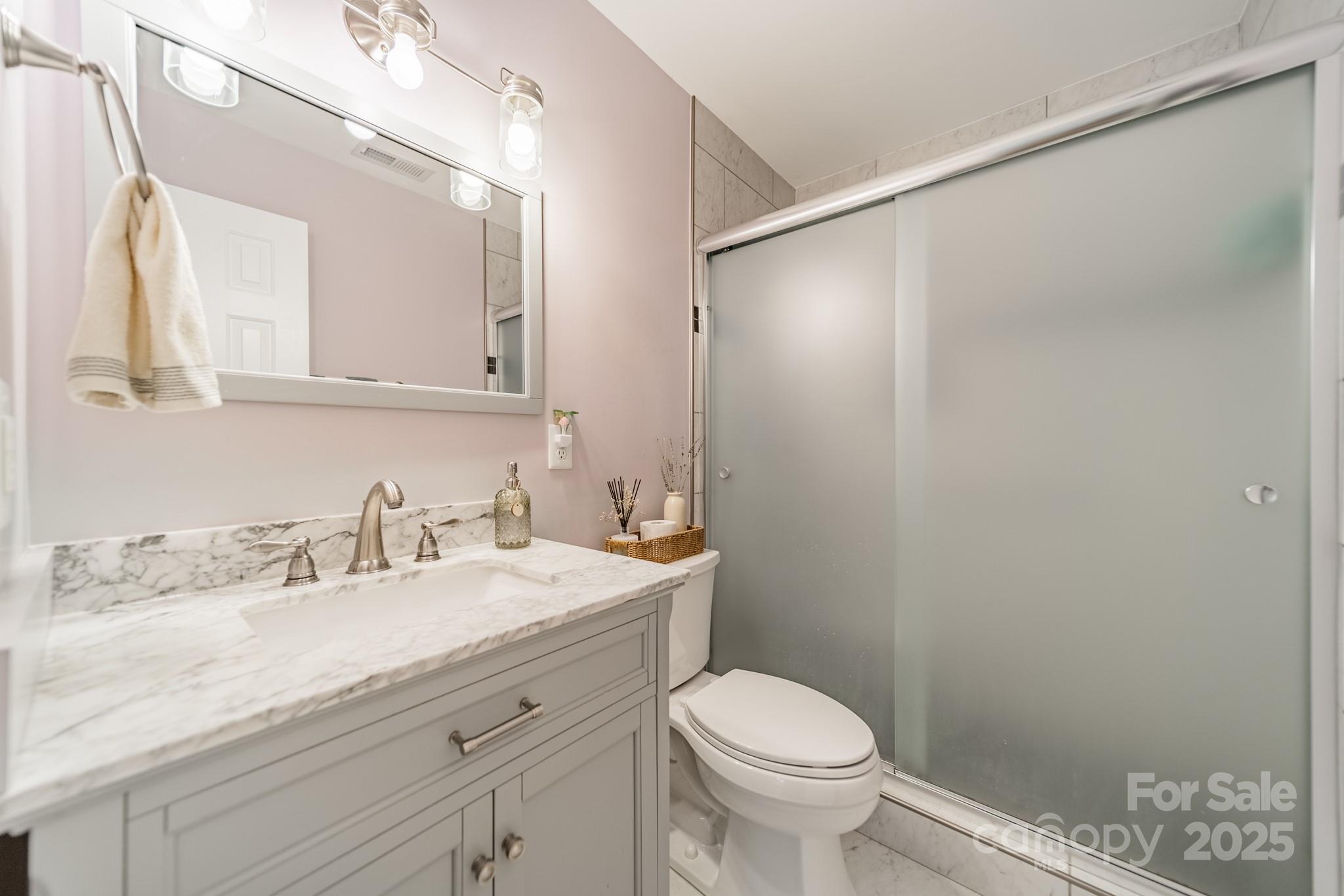 3414 Clearview Drive Monroe, NC 28110 - Photo 7 of 13 a bathroom with a granite countertop sink a toilet and a mirror