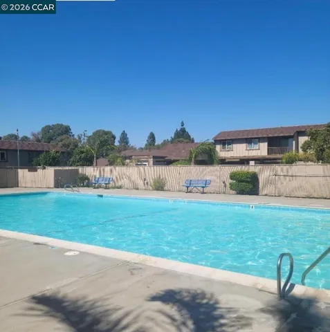 a view of backyard with seating area and trees