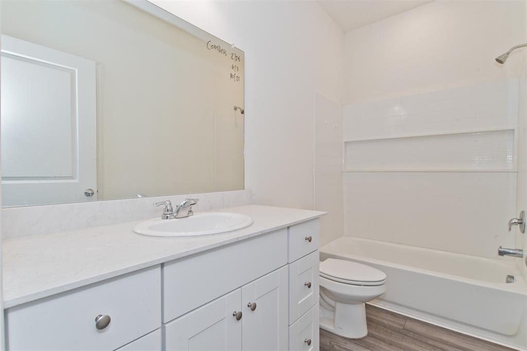 1637 Shadow Hawk Drive Fort Worth, TX 76052 - Photo 12 of 20 a bathroom with a sink a toilet and shower