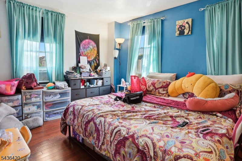 33 Pulaski Place Hackensack, NJ 07601 - Photo 22 of 31 a bedroom with bed and a chandelier