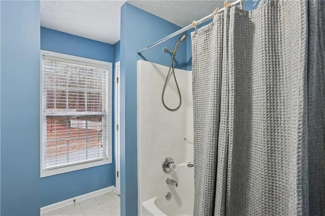 a bathroom with a shower and a window