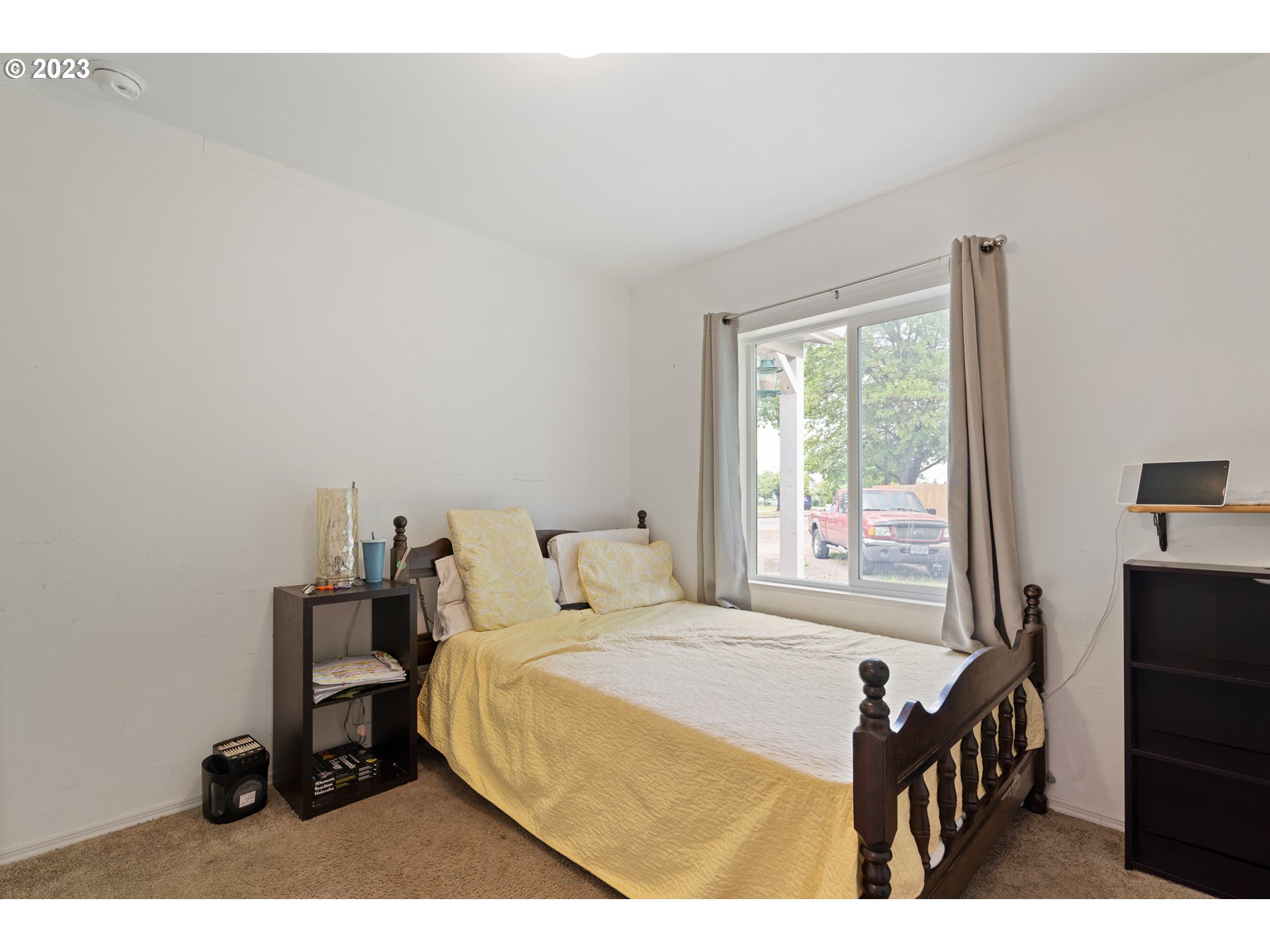1383 Taney Street Eugene, OR 97402 - Photo 18 of 23 a bedroom with a bed and a tv on a dresser