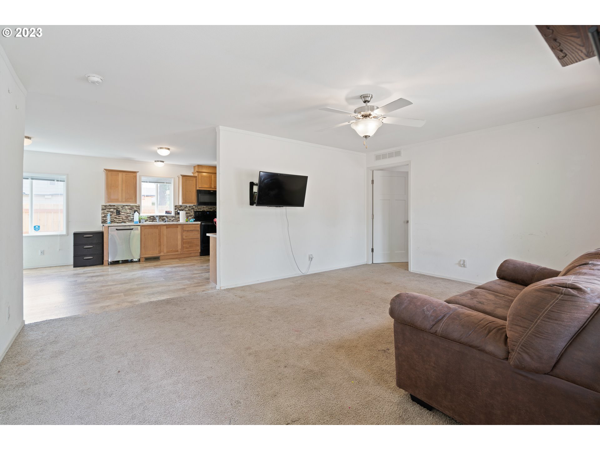 1383 Taney Street Eugene, OR 97402 - Photo 3 of 23 a living room with furniture and a flat screen tv