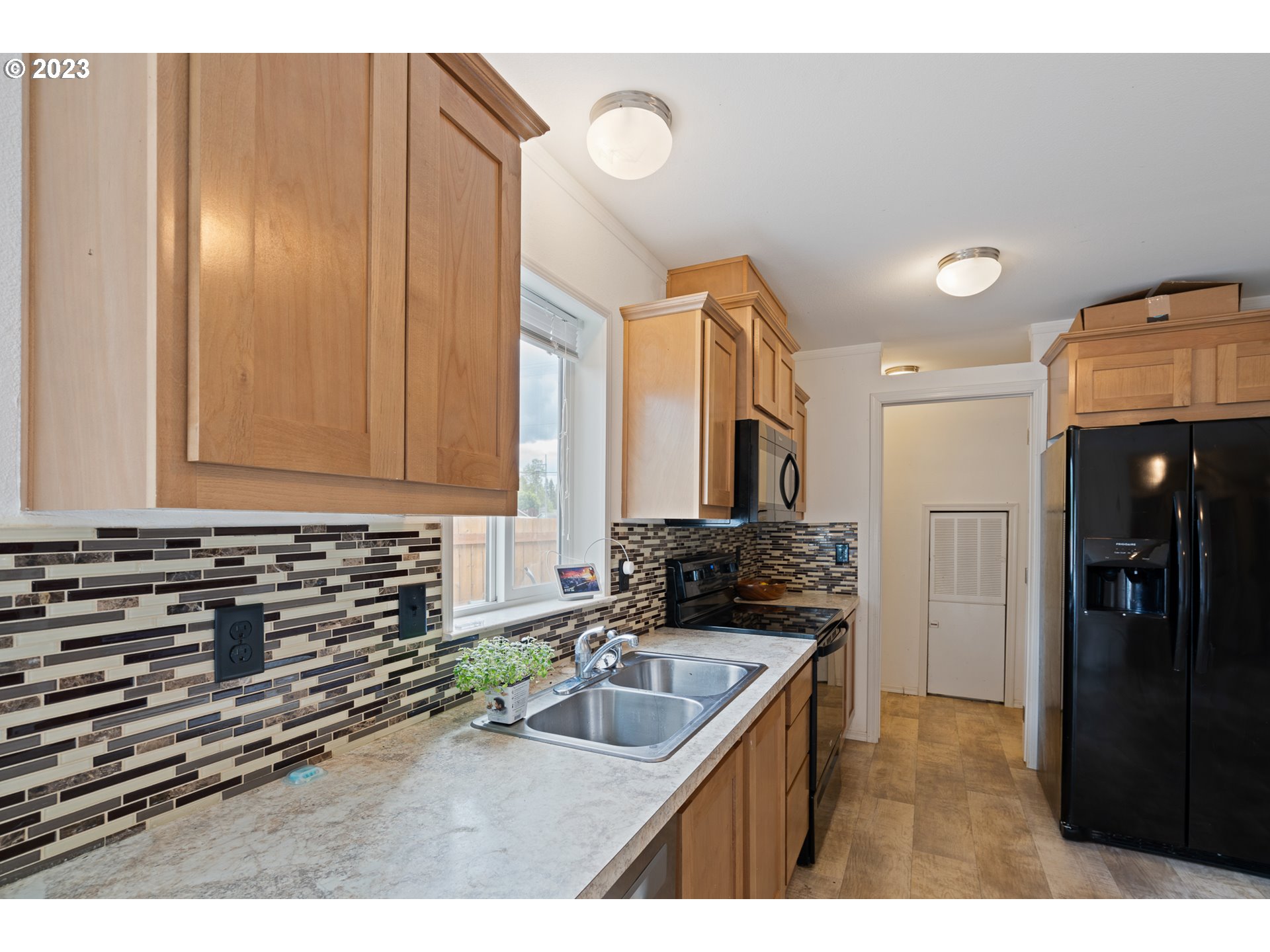 1383 Taney Street Eugene, OR 97402 - Photo 5 of 23 a kitchen with a sink and a refrigerator