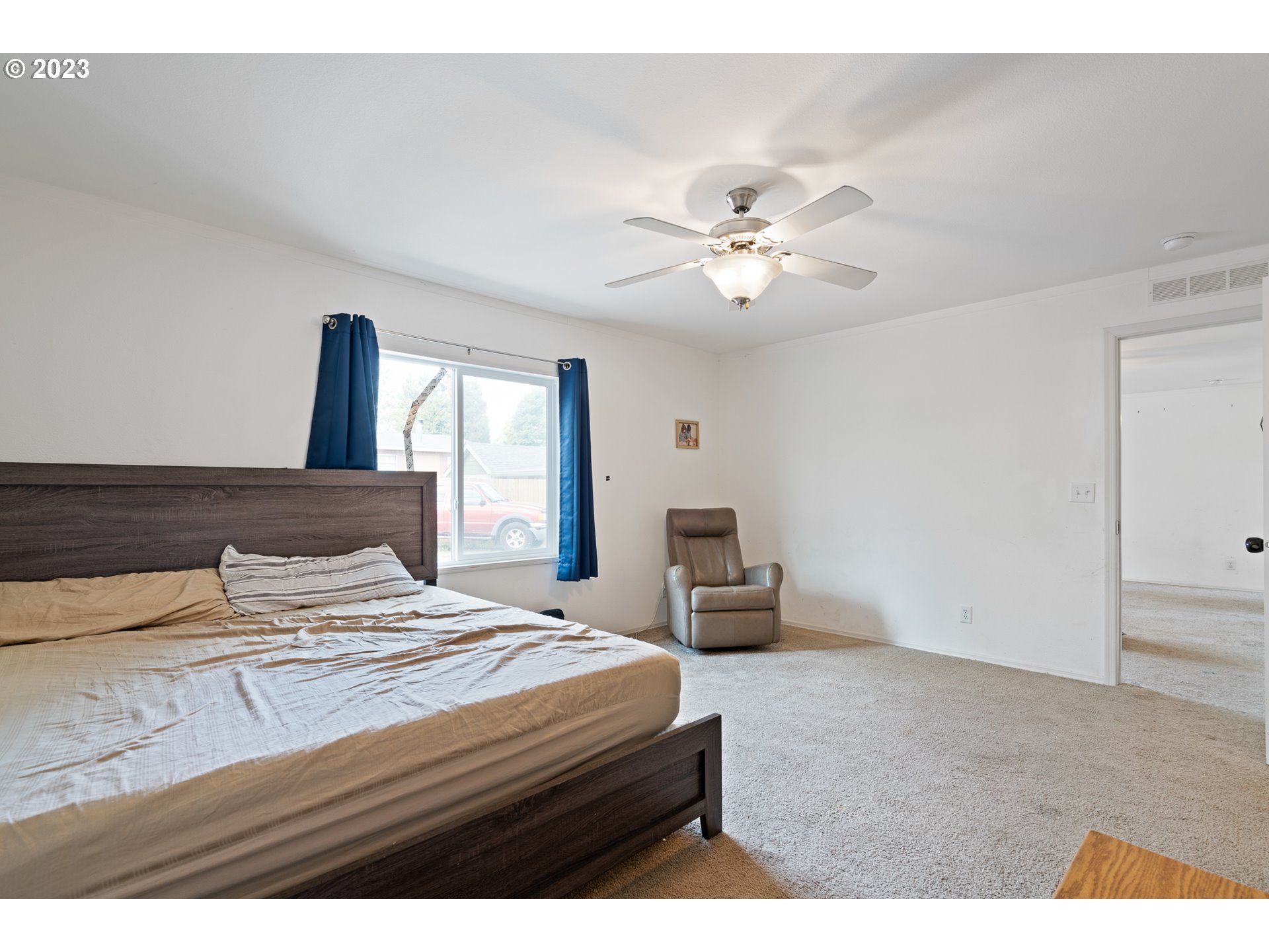 1383 Taney Street Eugene, OR 97402 - Photo 8 of 23 a bedroom with a bed and a chandelier