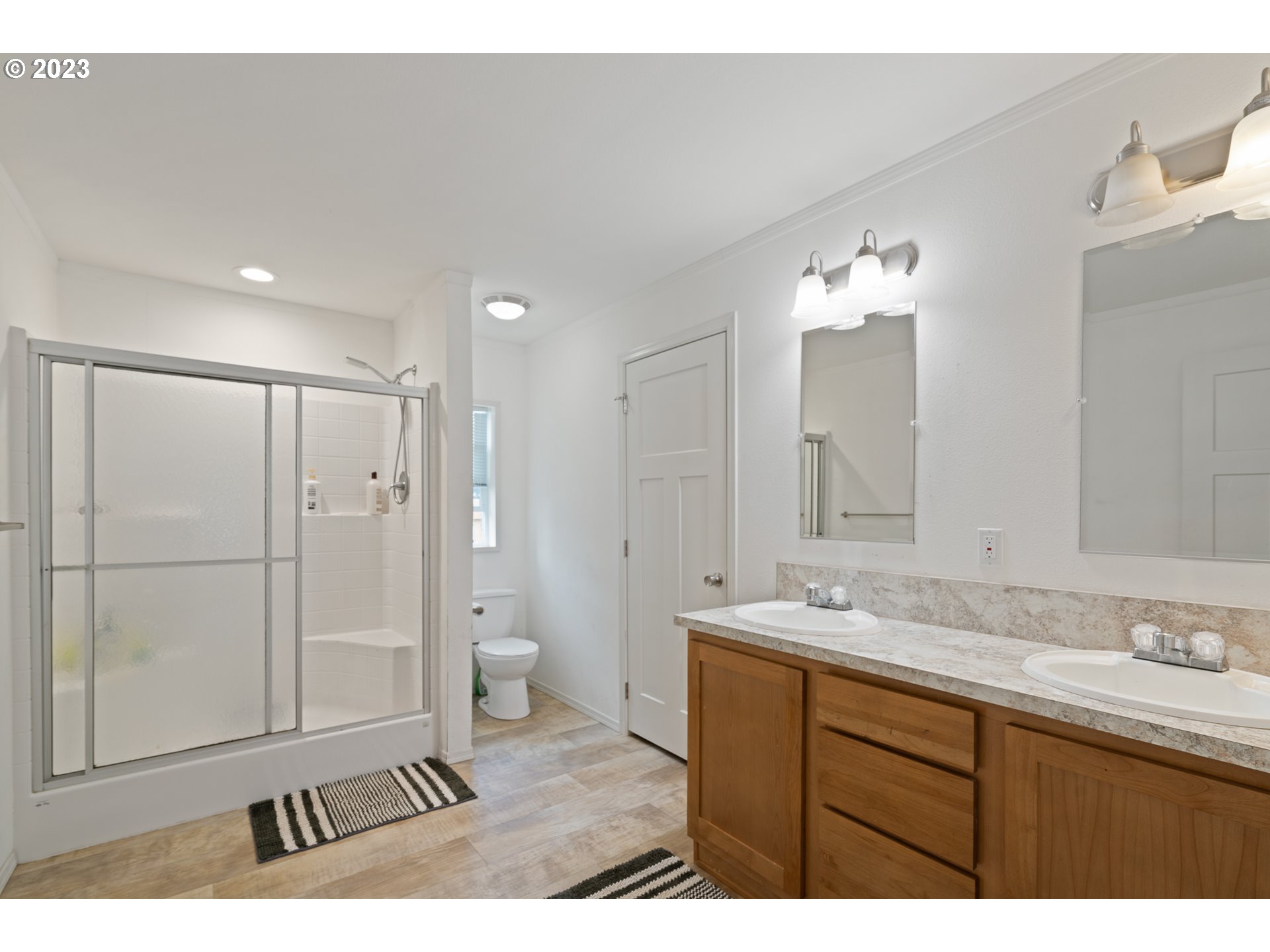 1383 Taney Street Eugene, OR 97402 - Photo 9 of 23 a bathroom with a shower sink and mirror