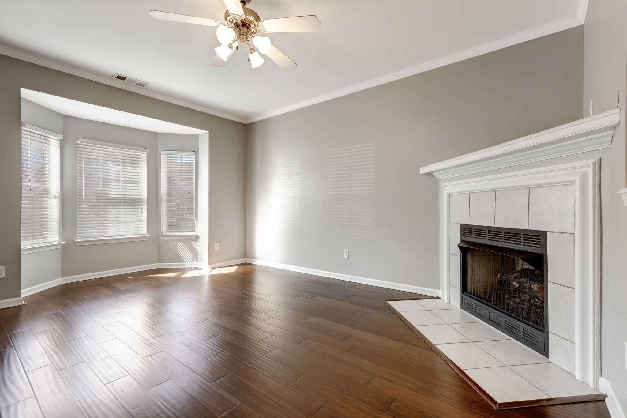 1101 Downs Boulevard, Unit 133 Franklin, TN 37064 - Photo 5 of 23 a view of an empty room with wooden floor fireplace and a window