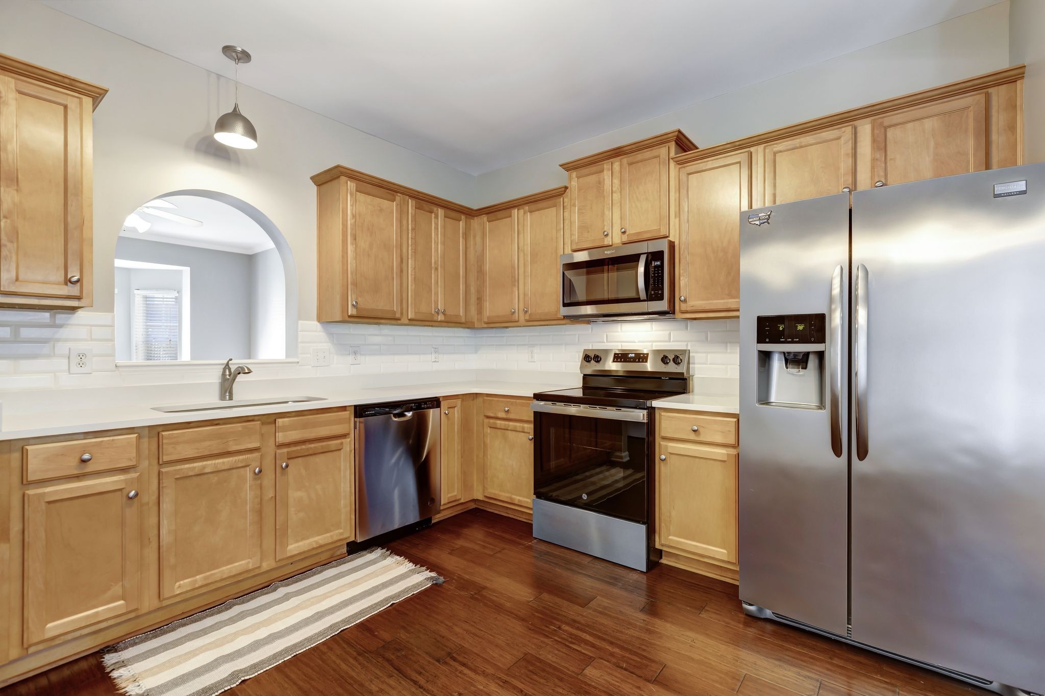 1101 Downs Boulevard, Unit 133 Franklin, TN 37064 - Photo 8 of 23 a kitchen with cabinets stainless steel appliances and a window
