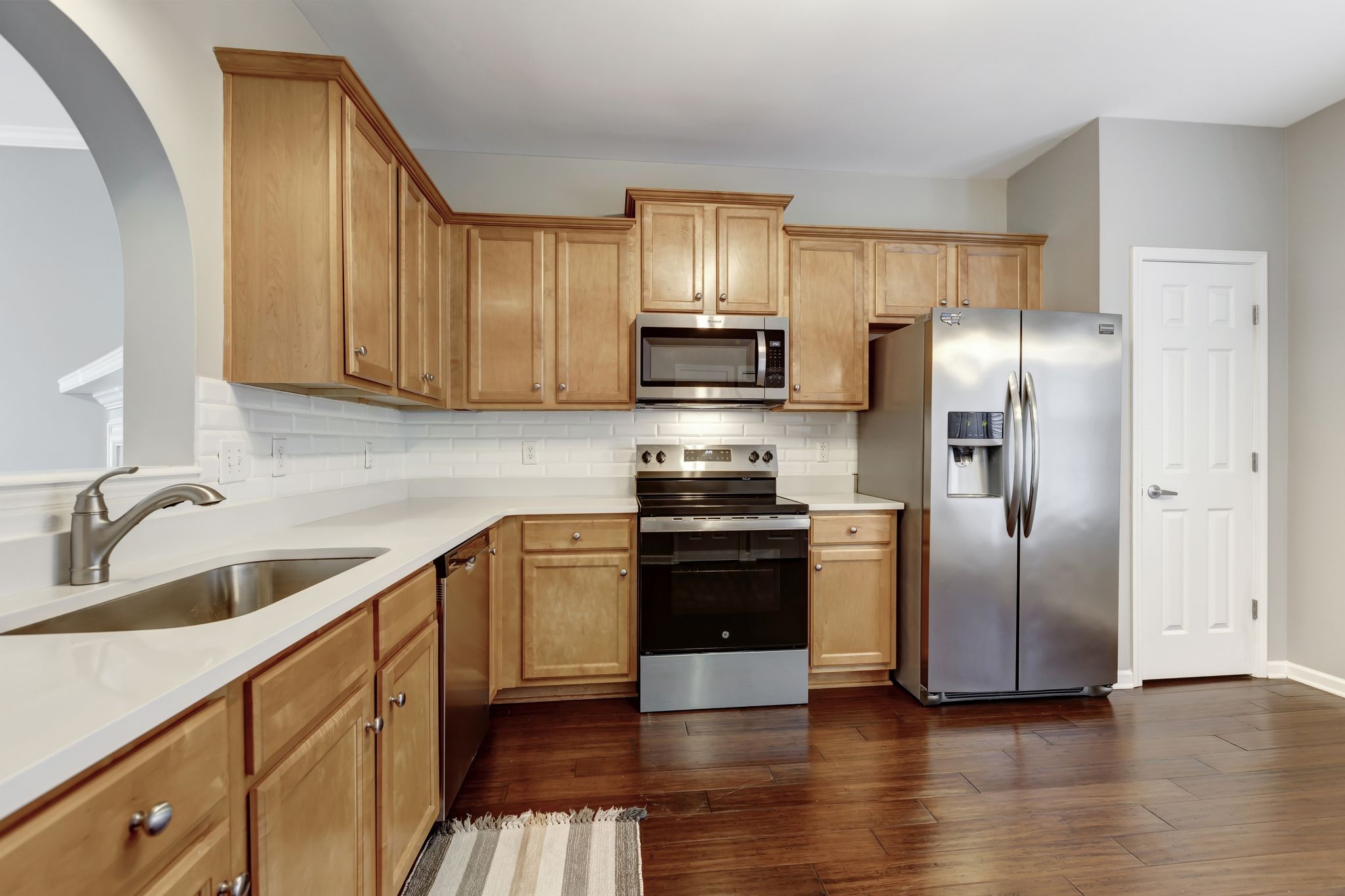 1101 Downs Boulevard, Unit 133 Franklin, TN 37064 - Photo 9 of 23 a kitchen with granite countertop a refrigerator stove and sink