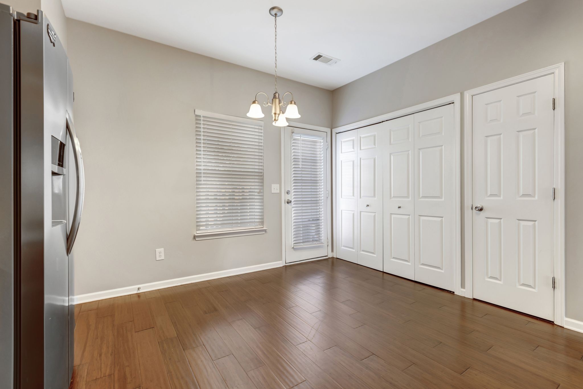 1101 Downs Boulevard, Unit 133 Franklin, TN 37064 - Photo 10 of 23 an empty room with wooden floor and windows
