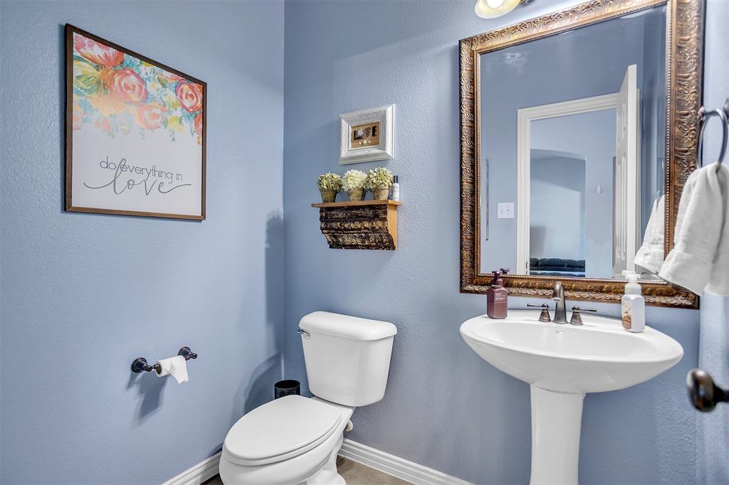 12286 Emerald Ranch Lane North Forney, TX 75126 - Photo 11 of 40 a bathroom with a toilet a sink and mirror