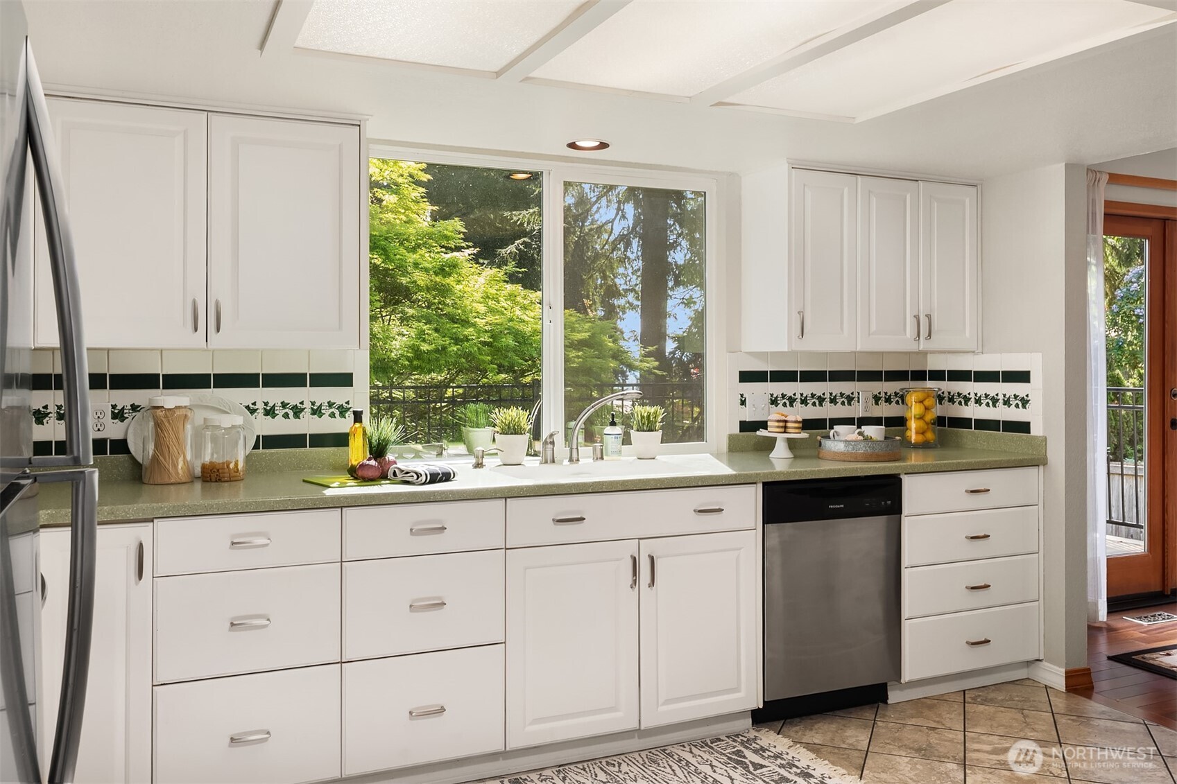 21331 2nd Avenue Southeast Bothell, WA 98021 - Photo 11 of 34 a kitchen with granite countertop white cabinets and white appliances