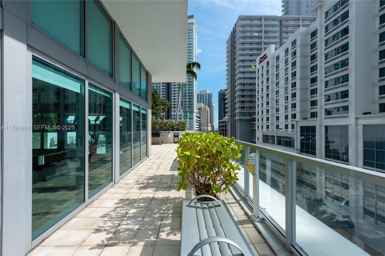 79 Southwest 12th Street, Unit 1107S Miami, FL 33130 - Photo 25 of 26 a view of balcony with wooden floor and windows
