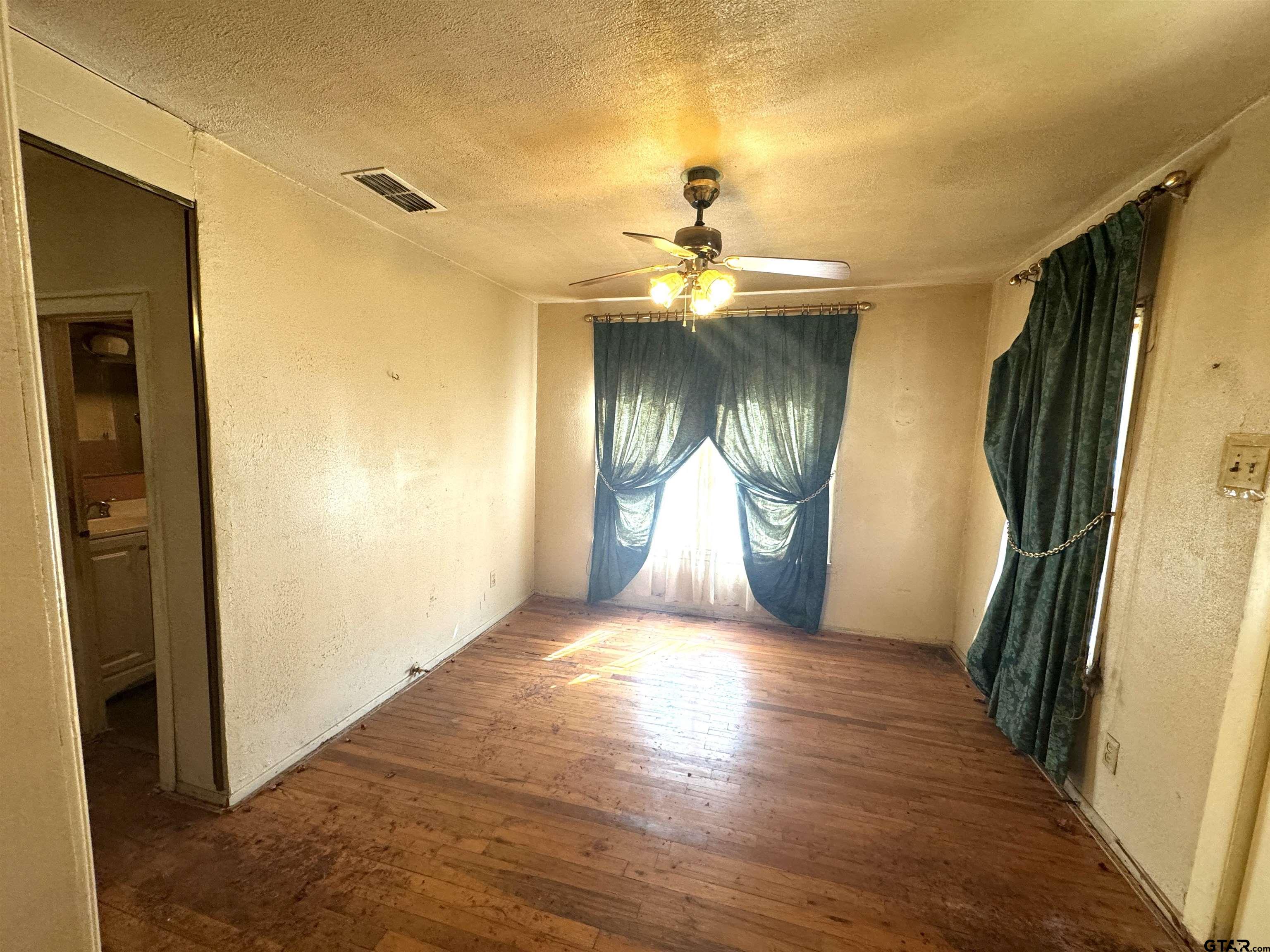 2017 West Jackson Street Tyler, TX 75701 - Photo 13 of 24 a view of a room with wooden floor and a ceiling fan
