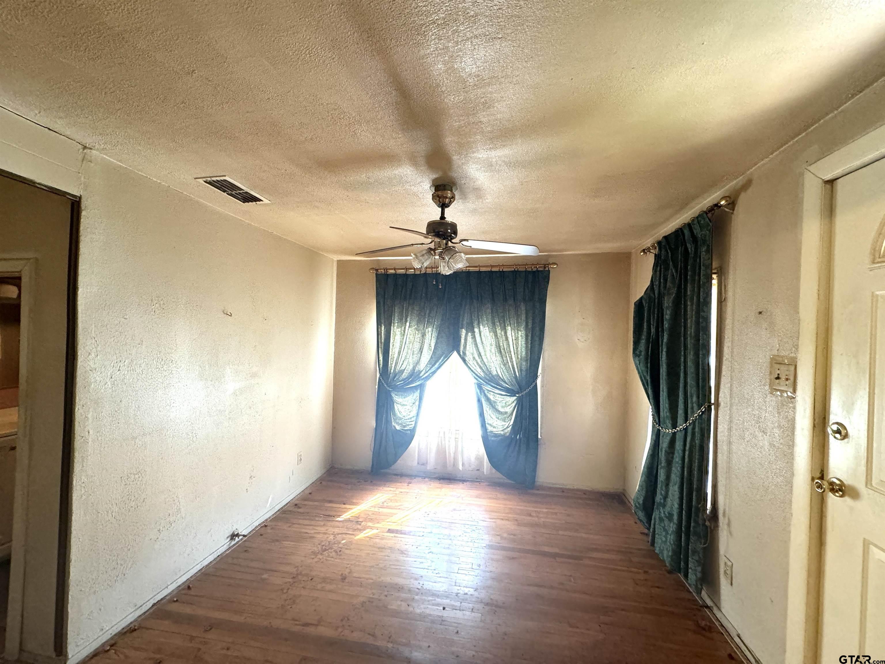 2017 West Jackson Street Tyler, TX 75701 - Photo 14 of 24 a view of empty room with wooden floor and fan