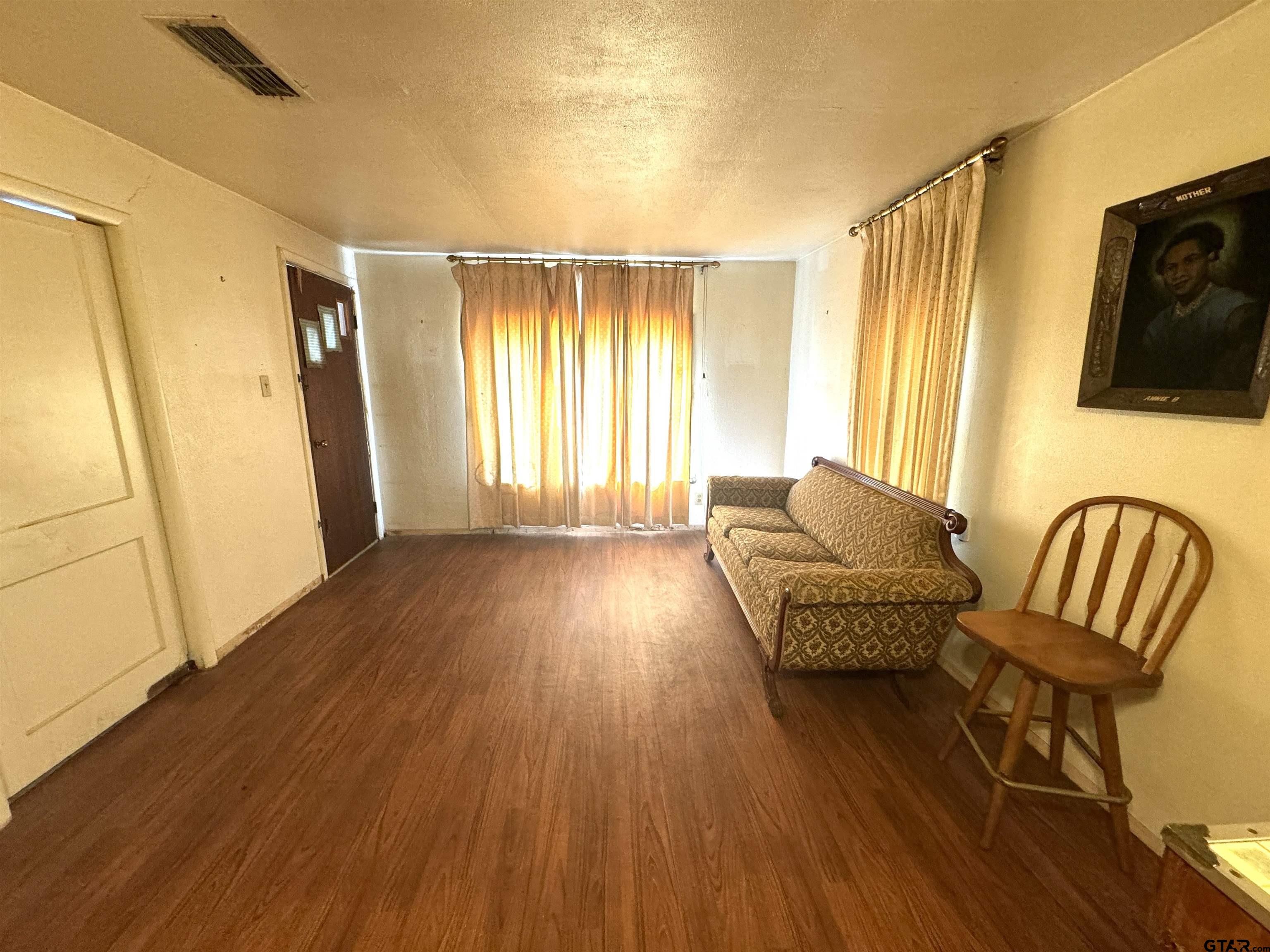 2017 West Jackson Street Tyler, TX 75701 - Photo 2 of 24 a living room with furniture and a flat screen tv