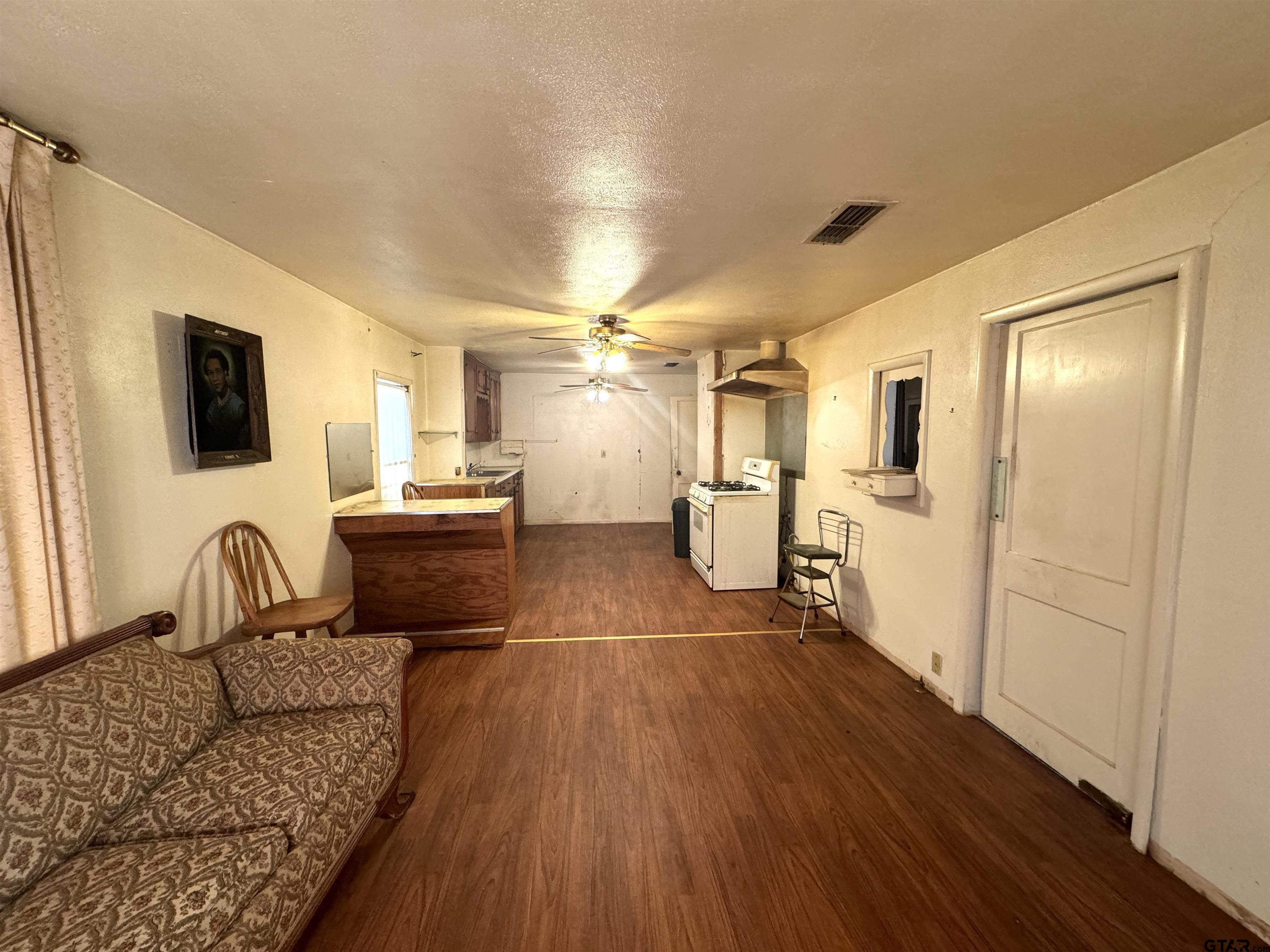 2017 West Jackson Street Tyler, TX 75701 - Photo 4 of 24 a living room with a couch and a view of kitchen
