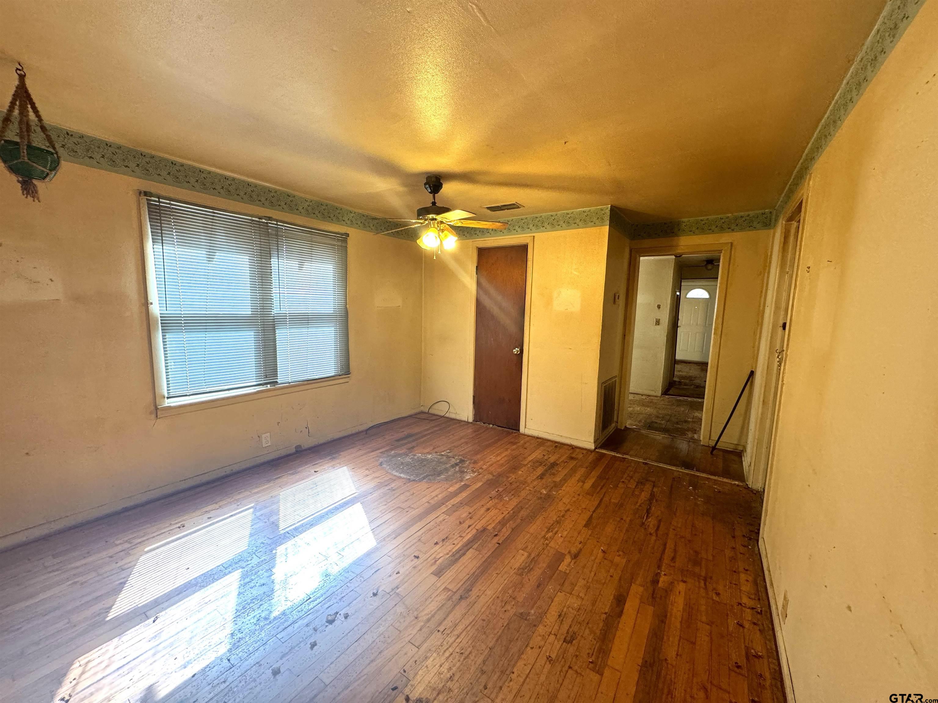 2017 West Jackson Street Tyler, TX 75701 - Photo 9 of 24 a view of an empty room with a window and wooden floor