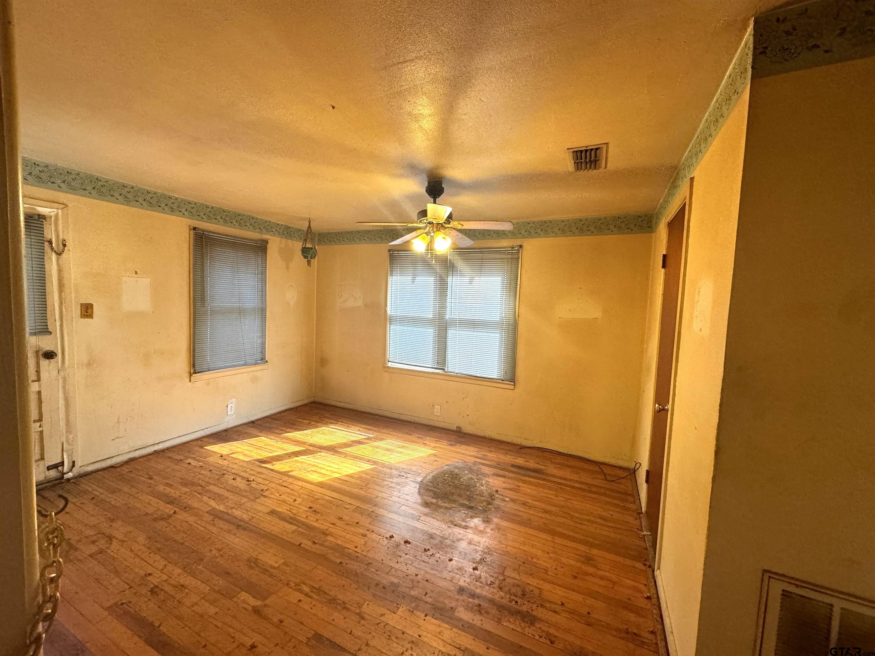 2017 West Jackson Street Tyler, TX 75701 - Photo 10 of 24 a view of an empty room with window and wooden floor