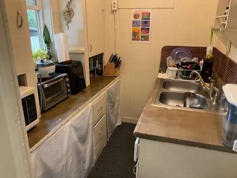 a bed sitting in a bedroom next to a window