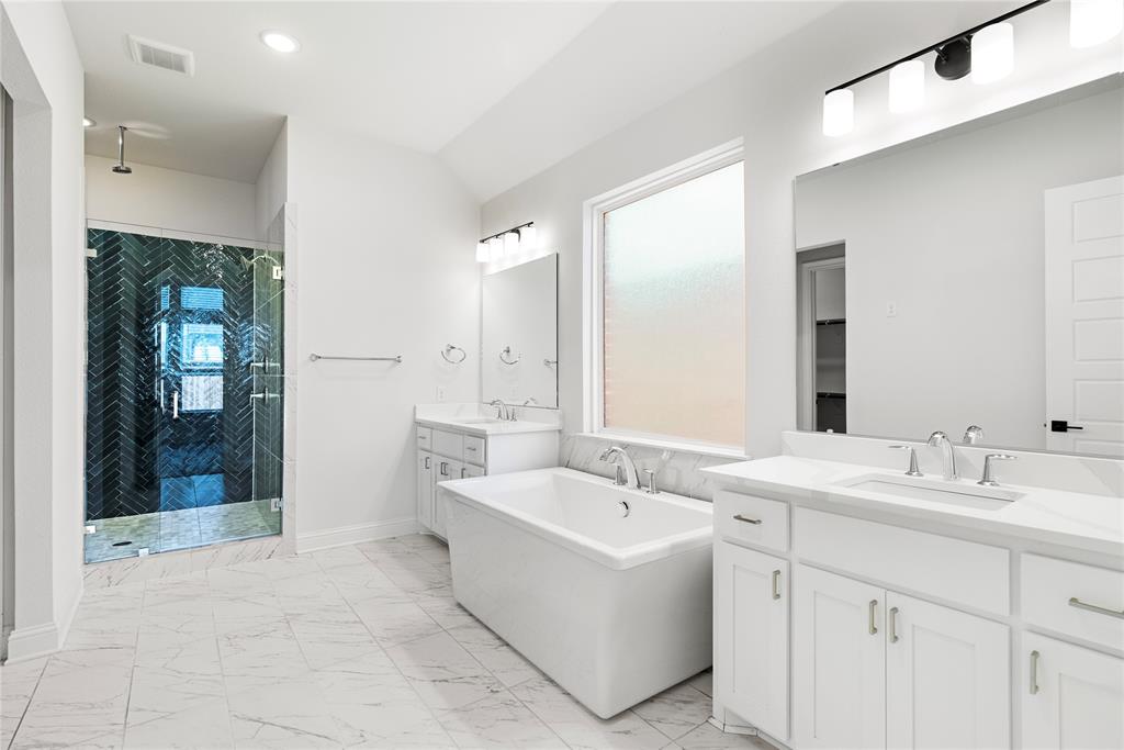 4405 Rosedale Street Prosper, TX 75078 - Photo 12 of 40 a spacious bathroom with a bathtub sink and mirror