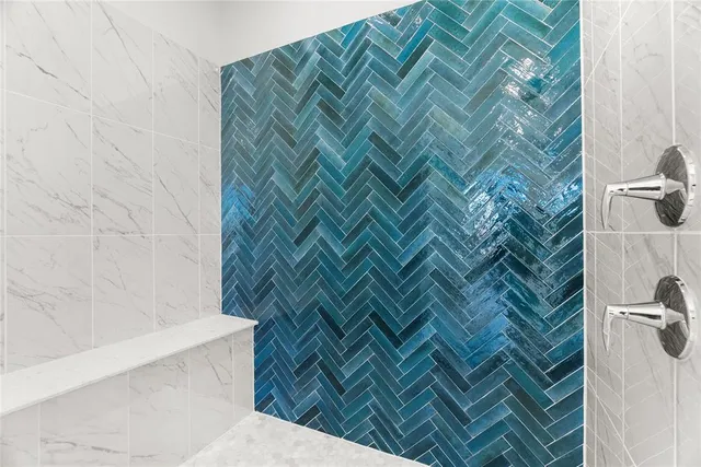 an empty room with chandelier fan and windows