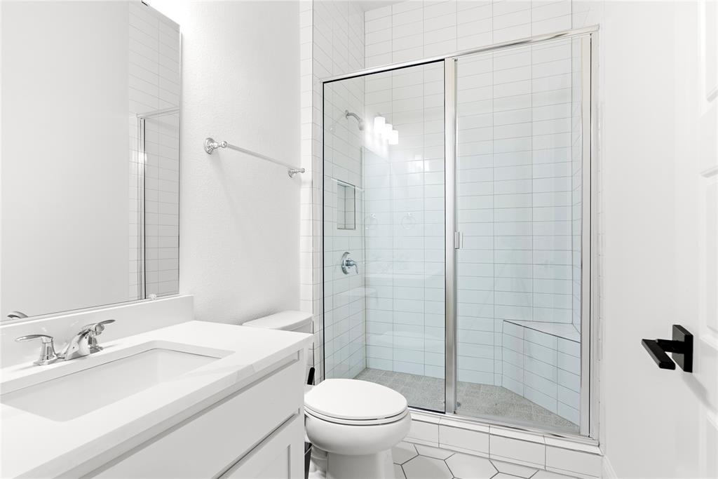 4405 Rosedale Street Prosper, TX 75078 - Photo 17 of 40 a bathroom with a shower a sink a toilet and a mirror