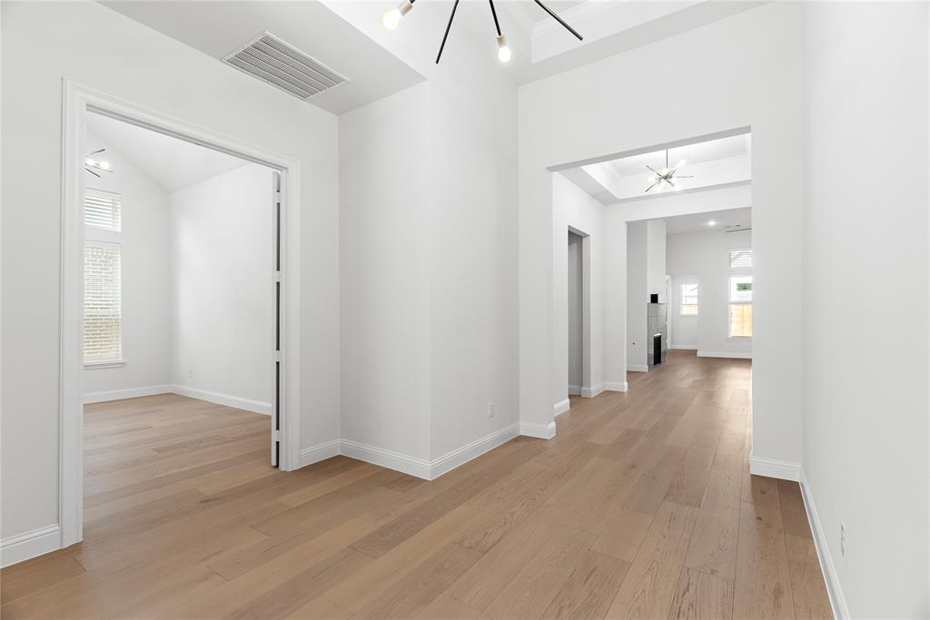 4405 Rosedale Street Prosper, TX 75078 - Photo 24 of 40 a view of a hallway with wooden floor