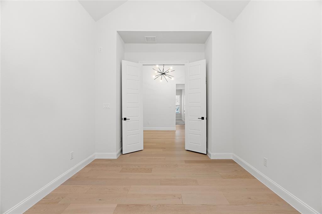 4405 Rosedale Street Prosper, TX 75078 - Photo 26 of 40 a view of a hallway with wooden floor