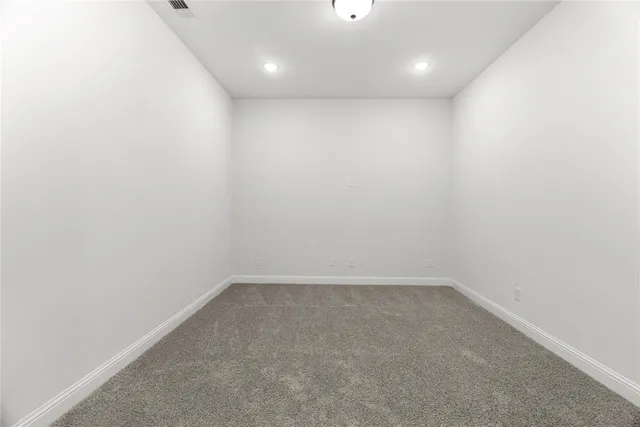 an empty room with a window and a ceiling fan