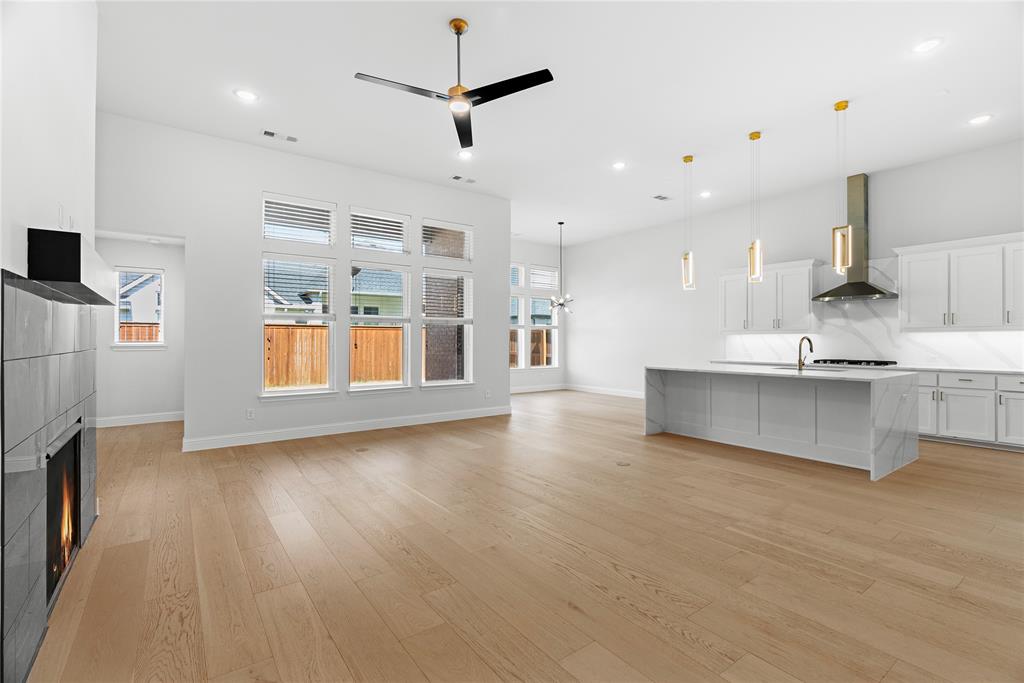 4405 Rosedale Street Prosper, TX 75078 - Photo 3 of 40 a view of large kitchen with a sink and a refrigerator