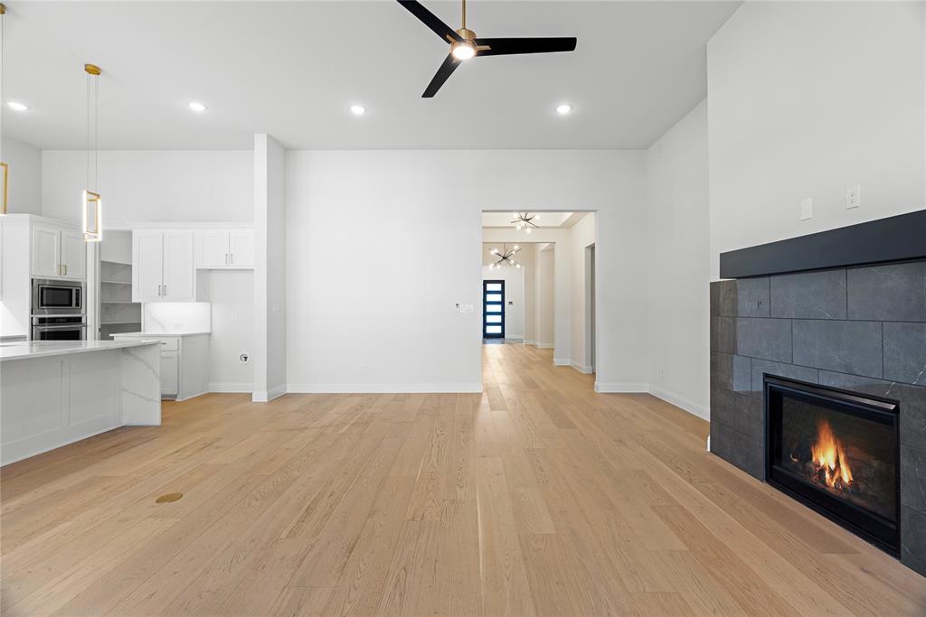 4405 Rosedale Street Prosper, TX 75078 - Photo 4 of 40 a view of a kitchen with a sink and a fireplace