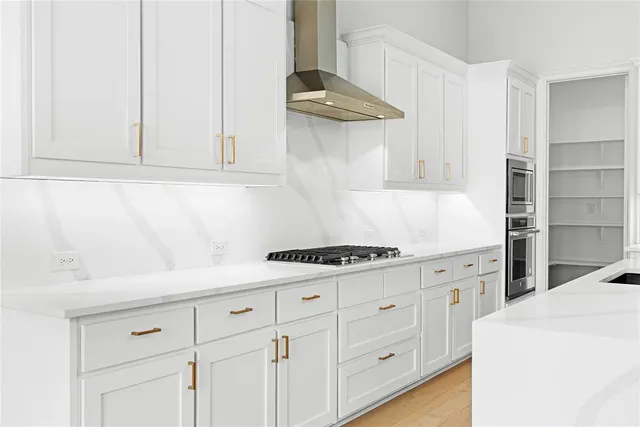a view of large kitchen with a sink and a refrigerator
