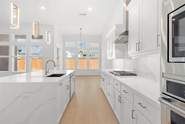 a view of a kitchen with a sink and a fireplace