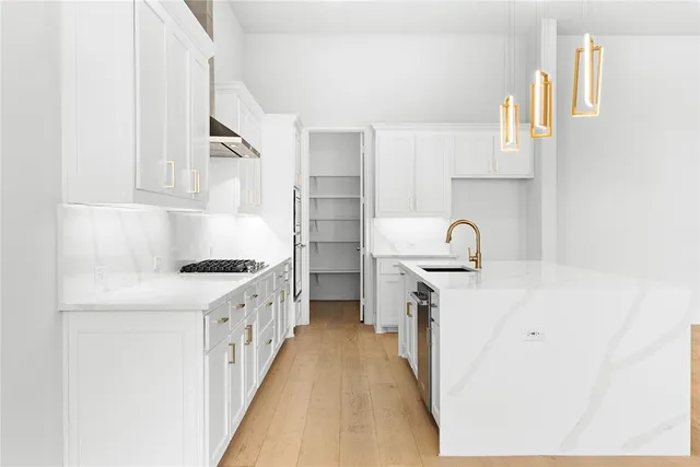 a kitchen with white cabinets and white appliances
