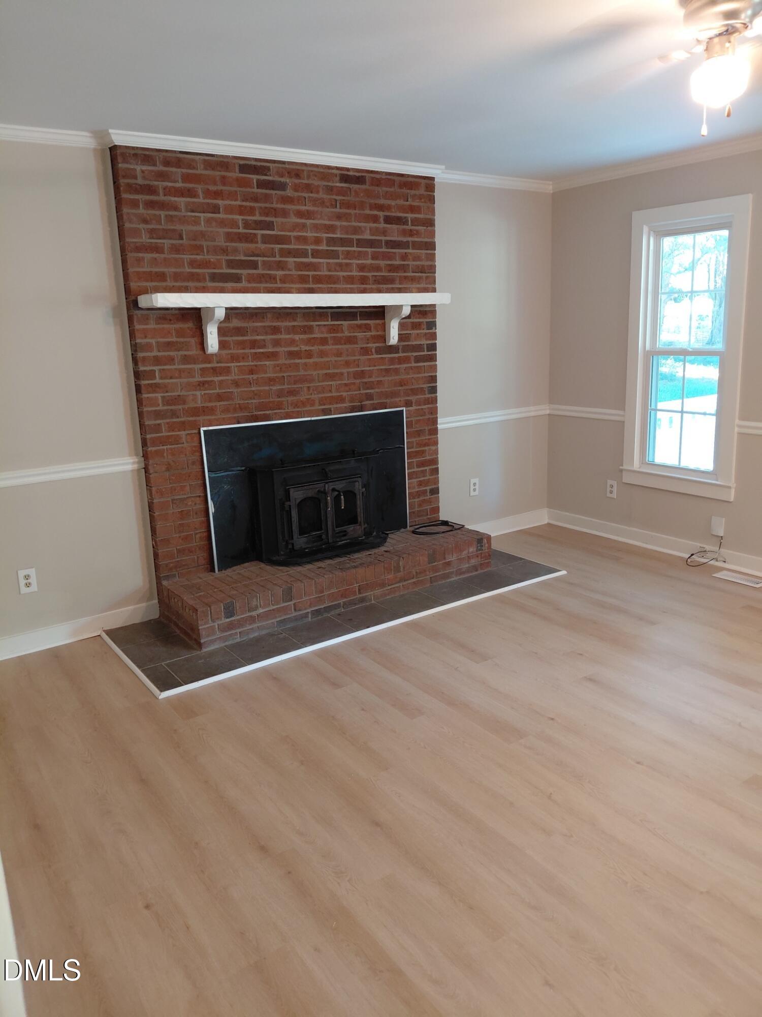 804 Olive Street Apex, NC 27502 - Photo 8 of 60 an empty room with windows and fireplace