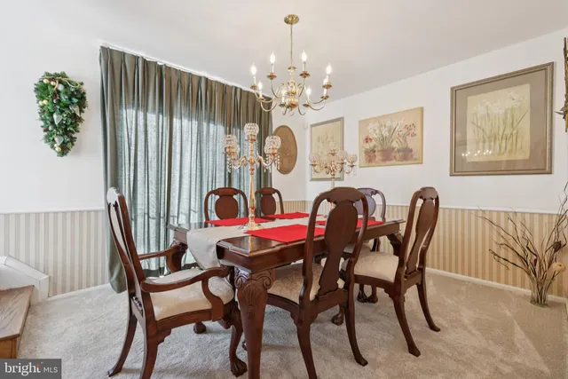 a view of a dining room with furniture and chandelier
