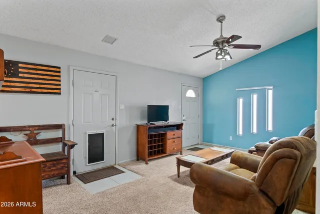 a living room with furniture a ceiling fan and a rug