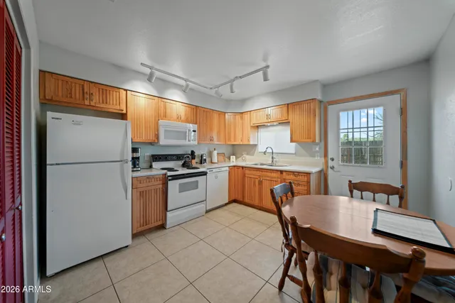 a kitchen with a sink stove top oven and cabinets