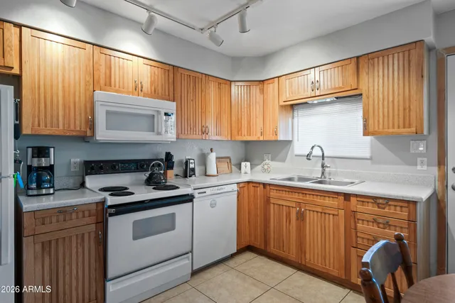 a kitchen with stainless steel appliances granite countertop a refrigerator sink and stove