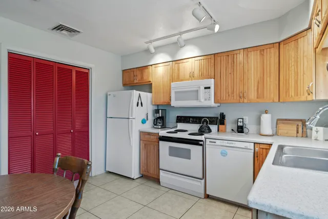 a kitchen with stainless steel appliances granite countertop a refrigerator sink and cabinets