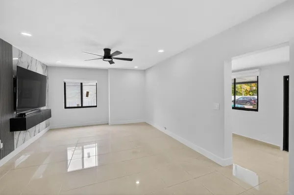 a view of livingroom with hardwood floor and a ceiling fan
