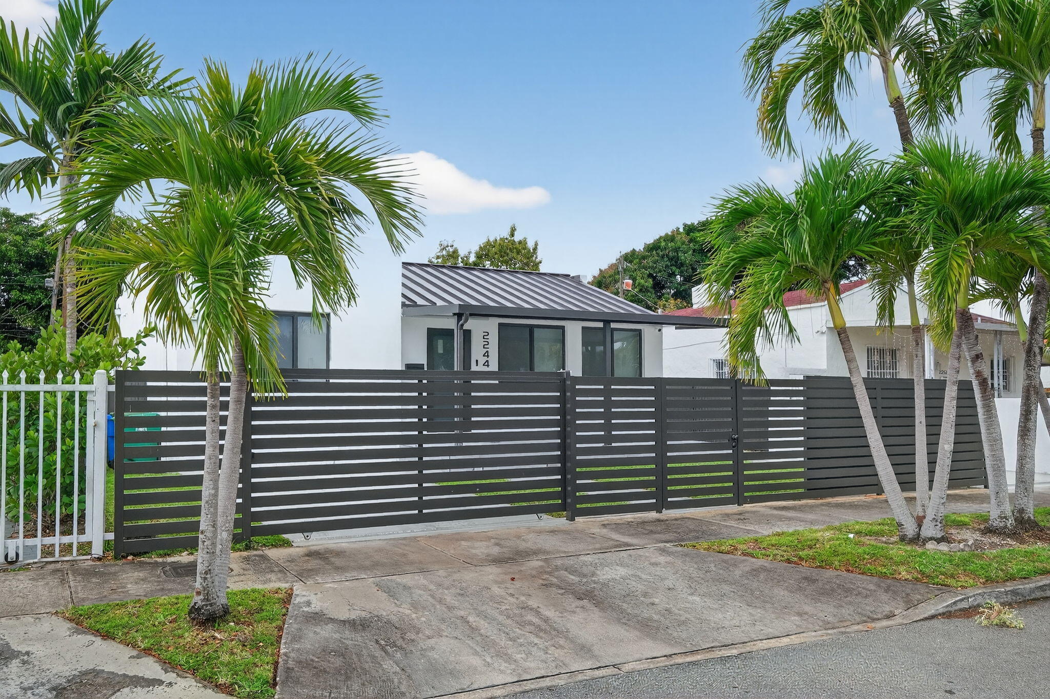 2244 Southwest 10th Street Miami, FL 33135 - Photo 2 of 40 a front view of a house with a yard and garage