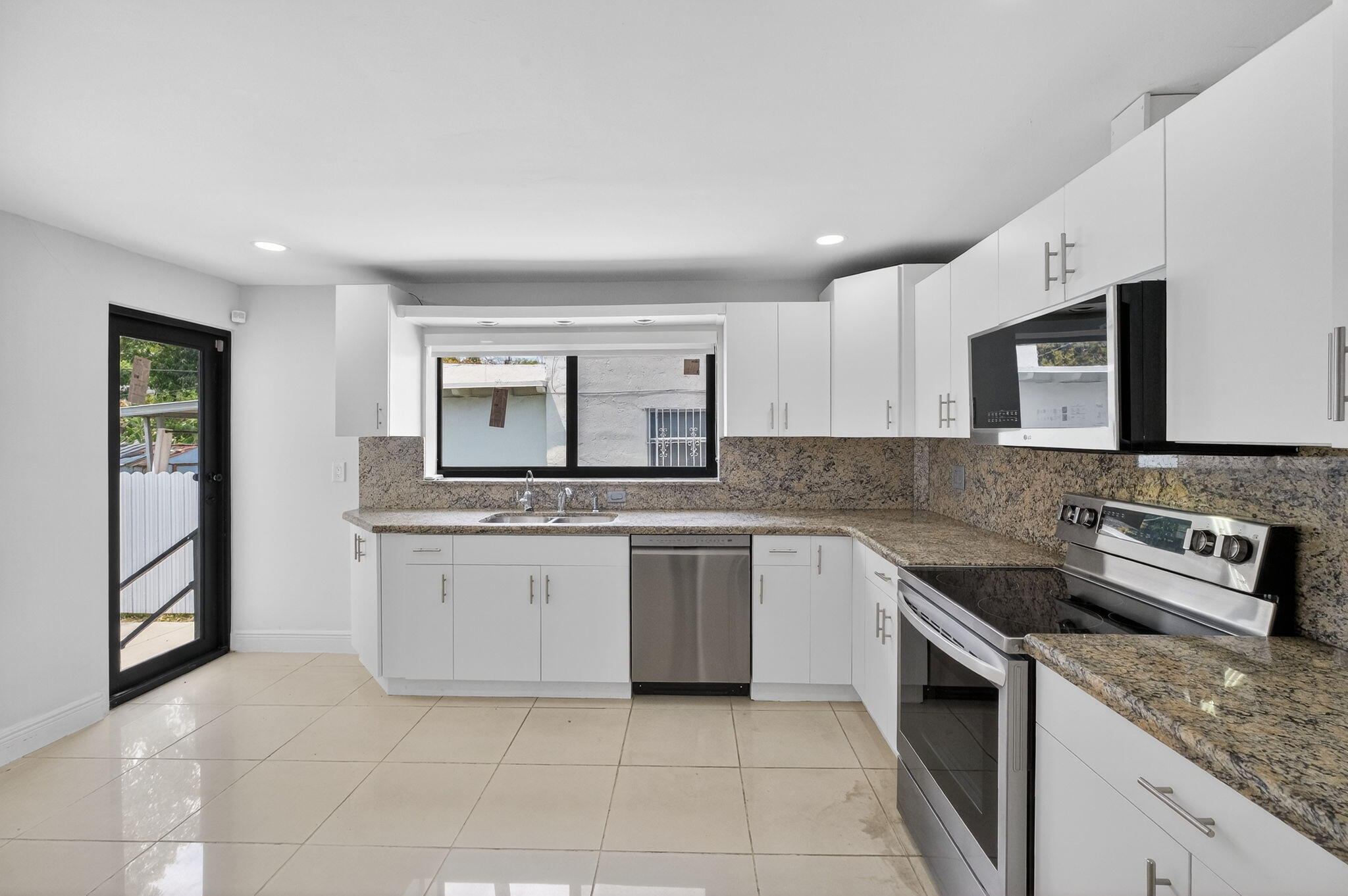 2244 Southwest 10th Street Miami, FL 33135 - Photo 21 of 40 a kitchen with stainless steel appliances granite countertop a stove and a sink