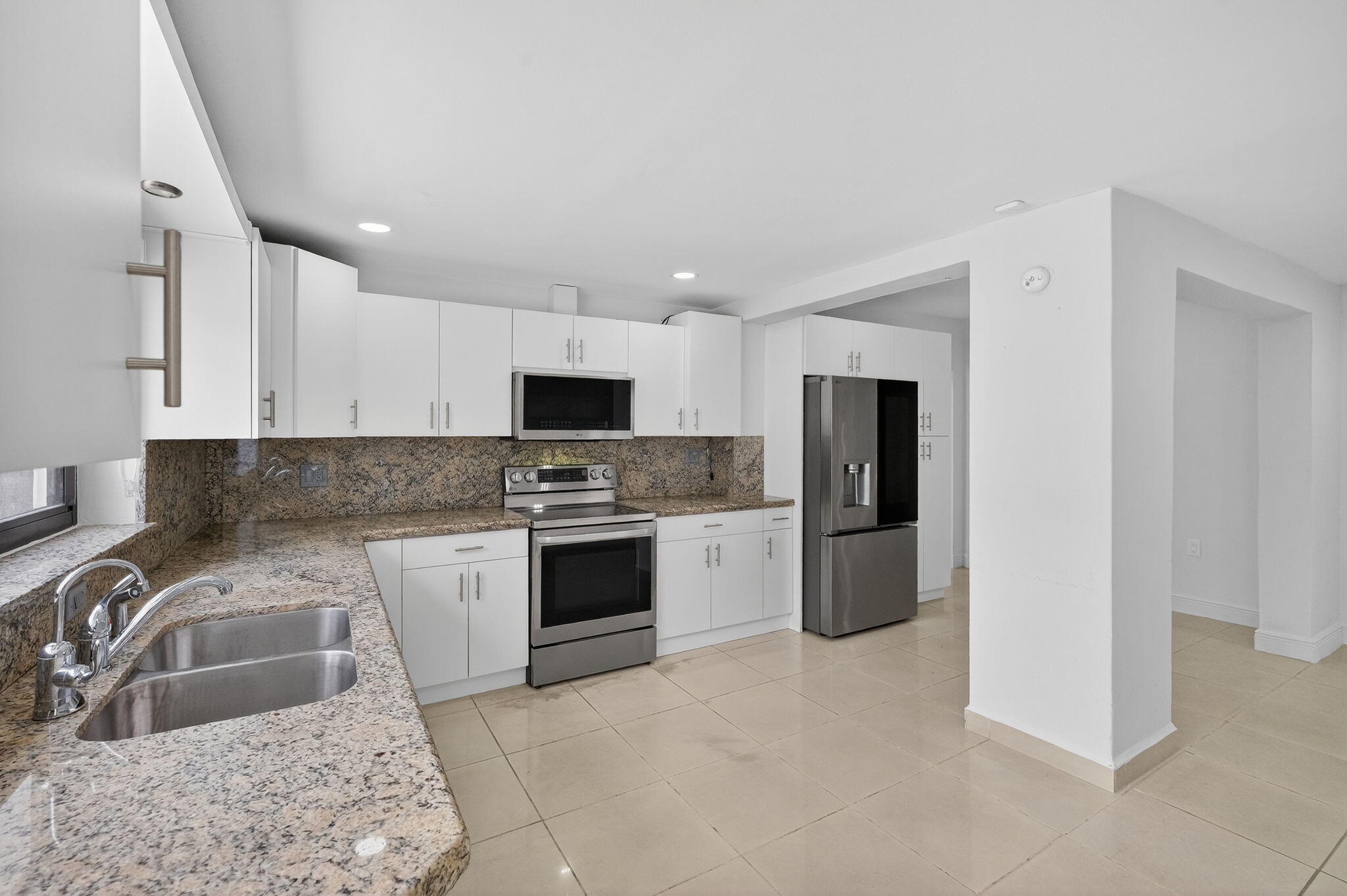 2244 Southwest 10th Street Miami, FL 33135 - Photo 22 of 40 a kitchen with stainless steel appliances granite countertop a sink stove and refrigerator