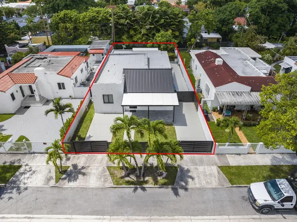 an aerial view of residential houses with city view