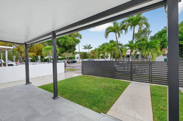 a view of a back yard from a balcony